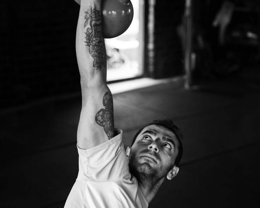 high-angle-man-training-with-kettlebell-b